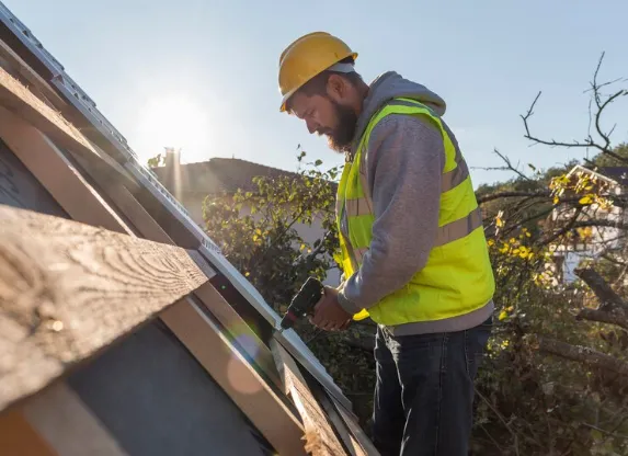 man fitting a wooden ceiling